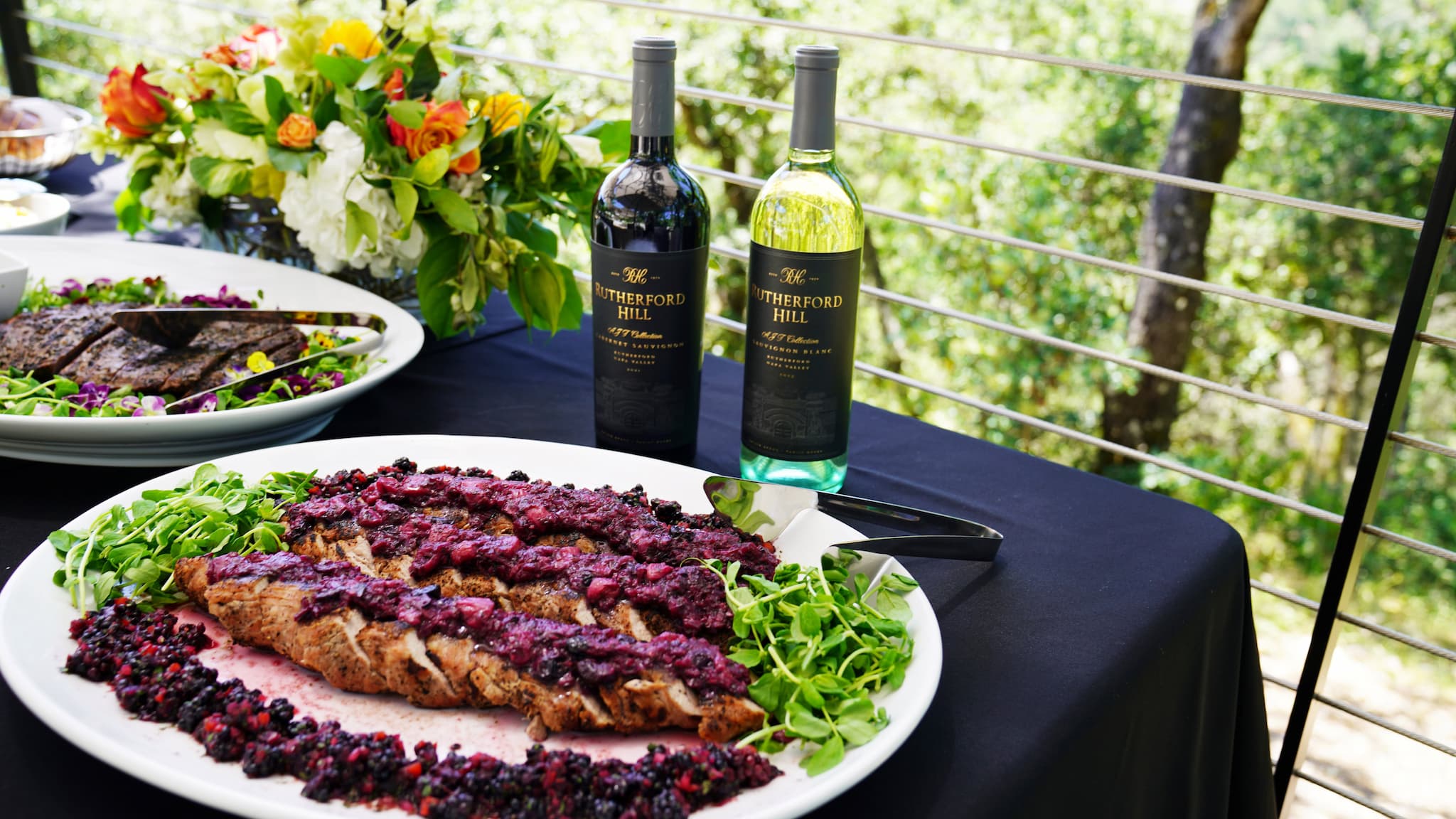 Wine bottles with gourmet plated meat dish