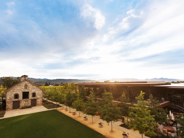 Stone barn and vineyard estate at sunset