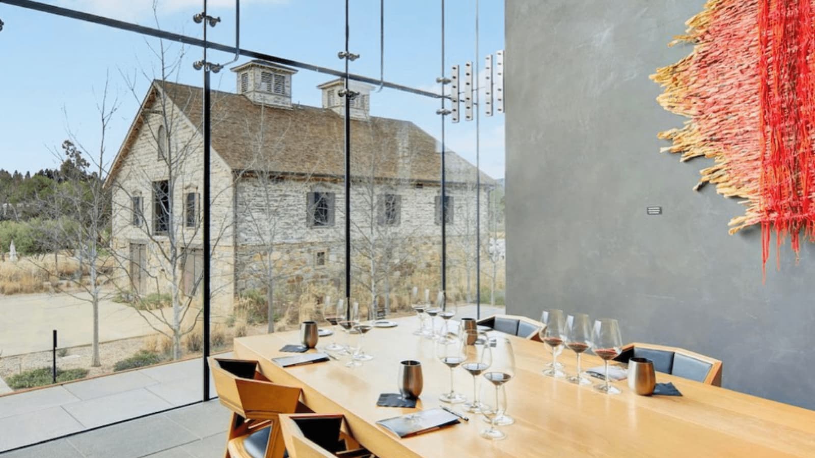 Modern dining room with scenic barn view.