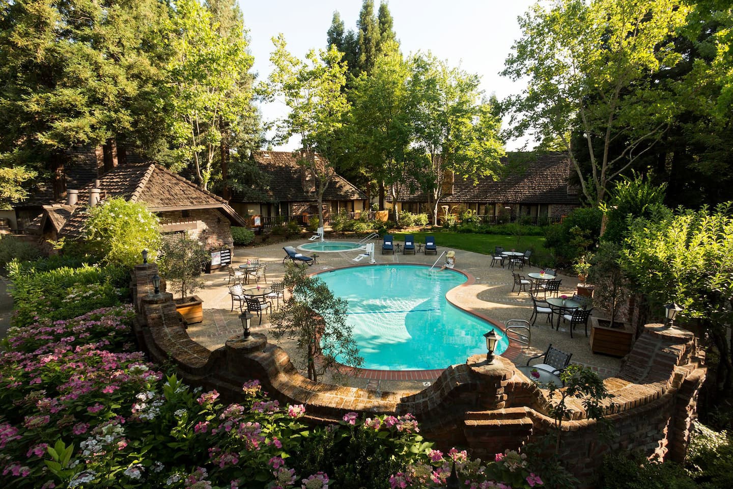 Landscaped courtyard with pool and surrounding cottages