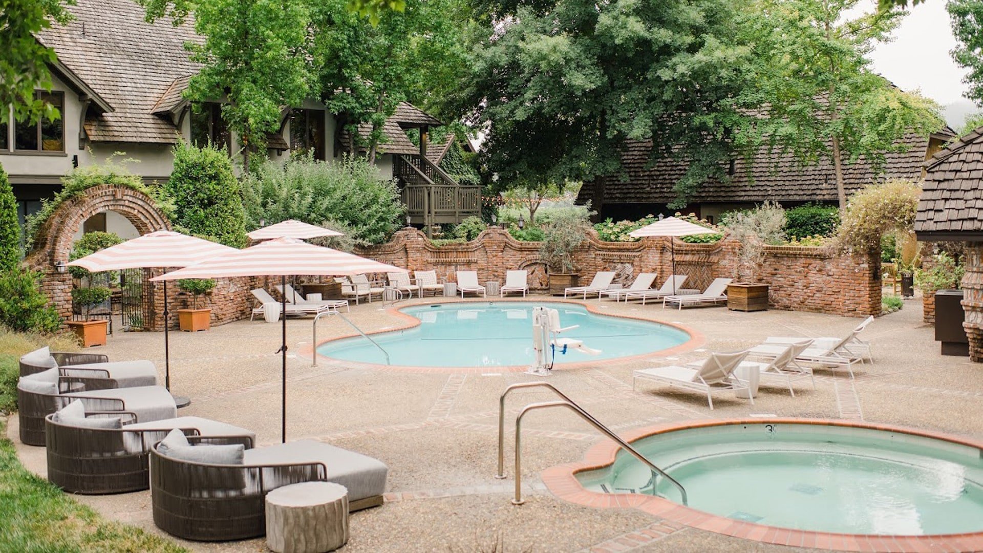 Charming outdoor pool area with seating and umbrellas.