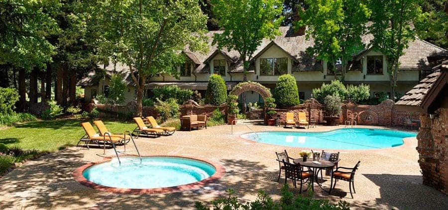 Lush courtyard with pool and seating area.