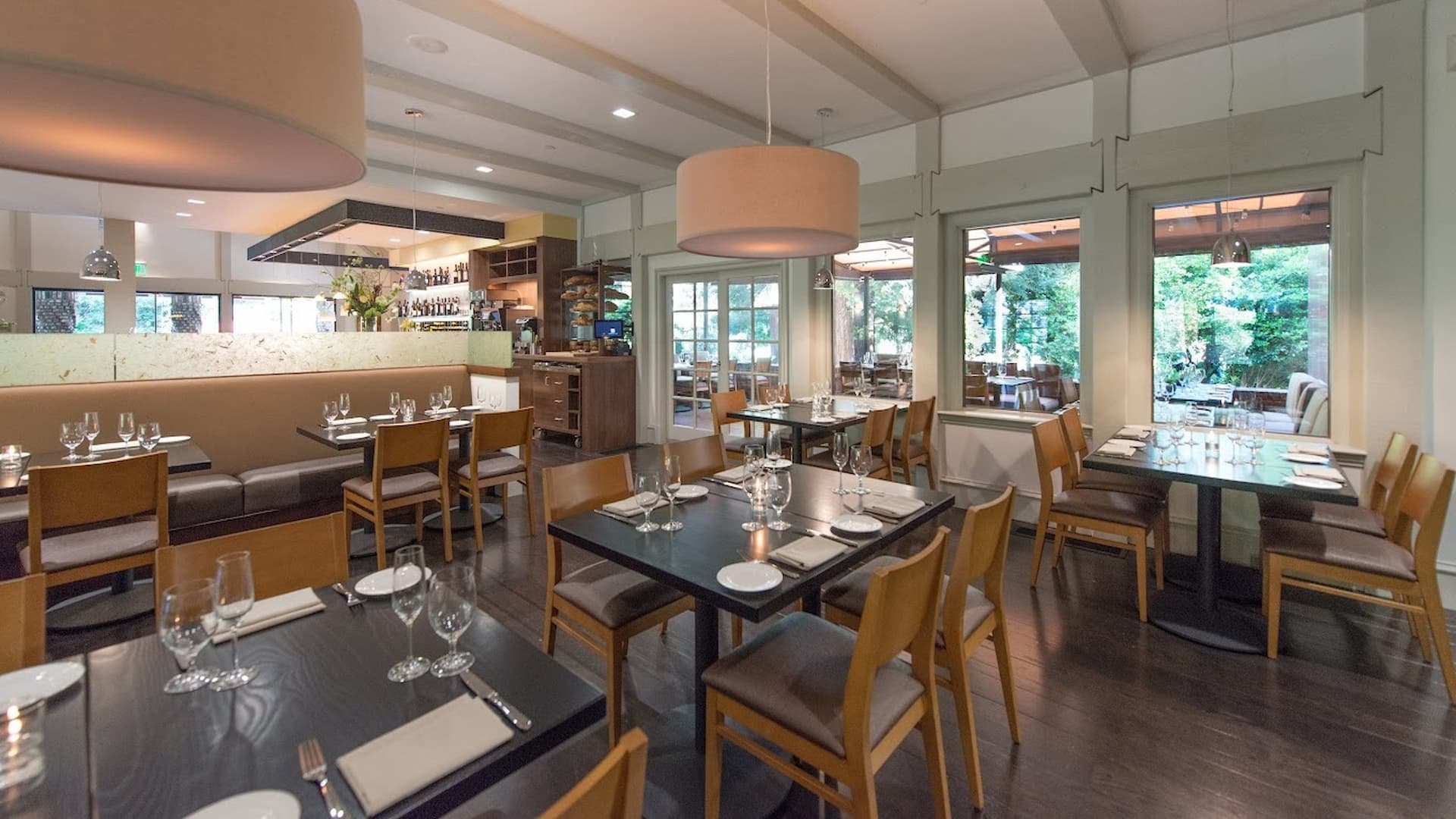 Elegant restaurant interior with tables set for dining.