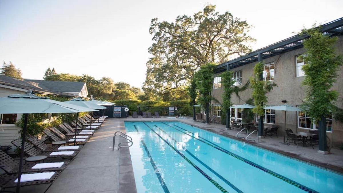 Outdoor pool with lounge chairs and umbrellas