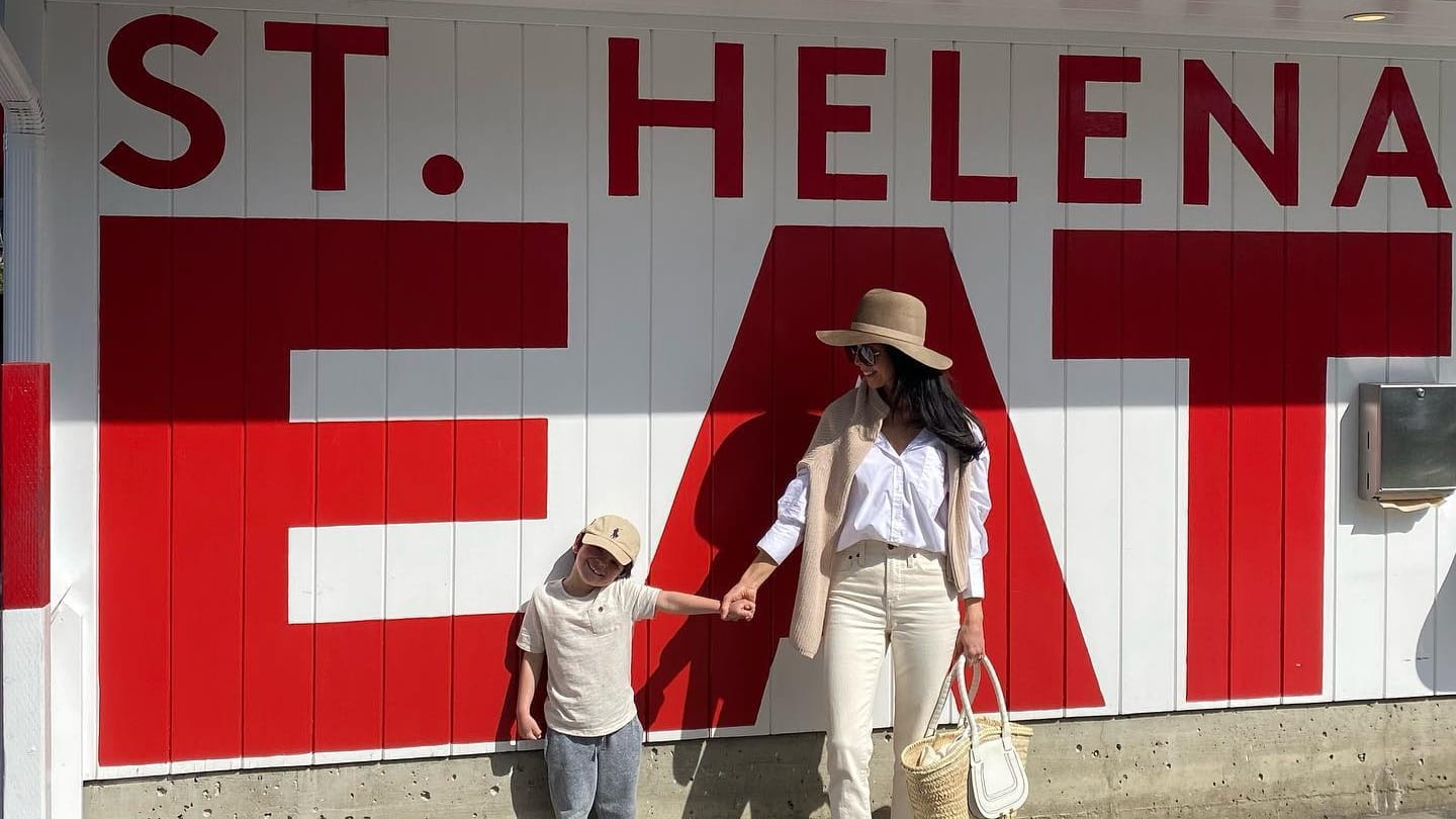 Woman and child by St. Helena EAT sign