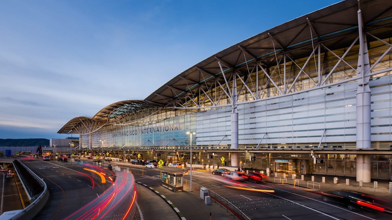 San Francisco International Airport terminal exterior at dusk.