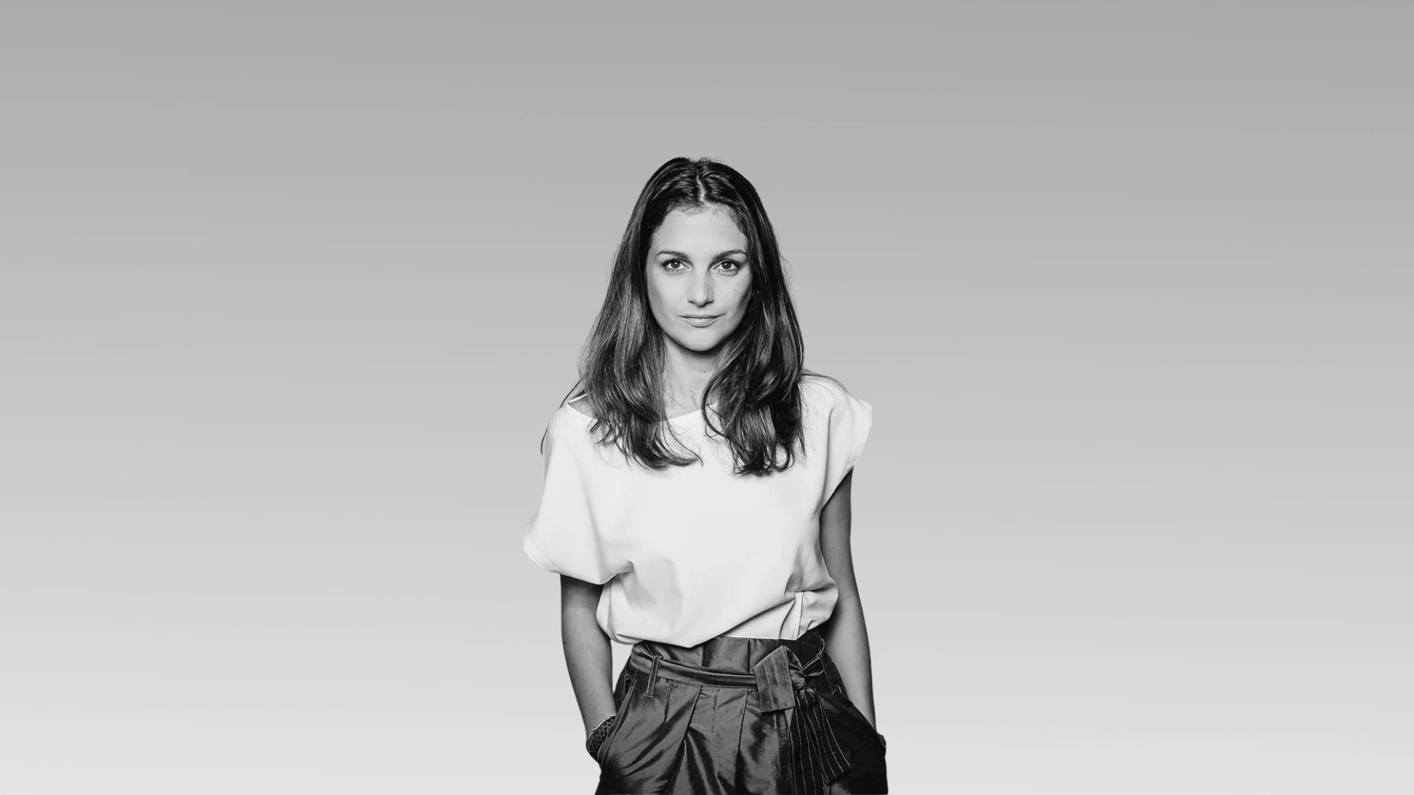 Black-and-white portrait of woman against plain background