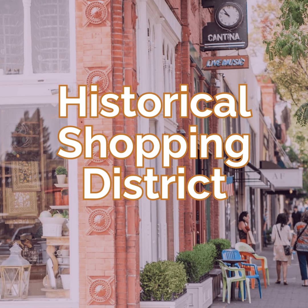 Historical shopping district with brick buildings and shops.