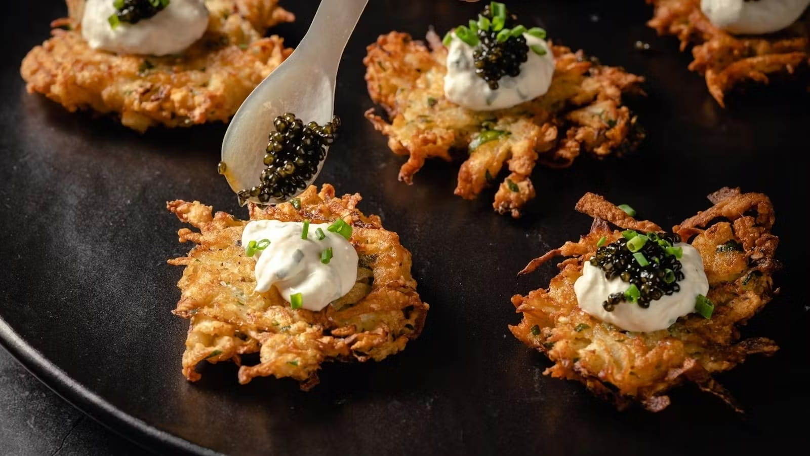 Gourmet latkes with caviar and cream topping