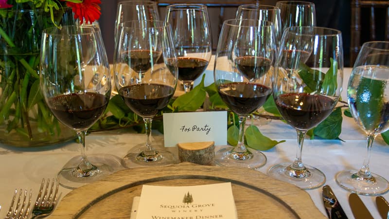 Wine glasses arranged on elegant dinner table.