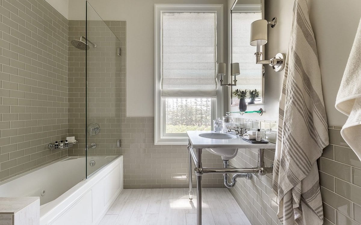 Modern bathroom with tub and stylish gray tiles.