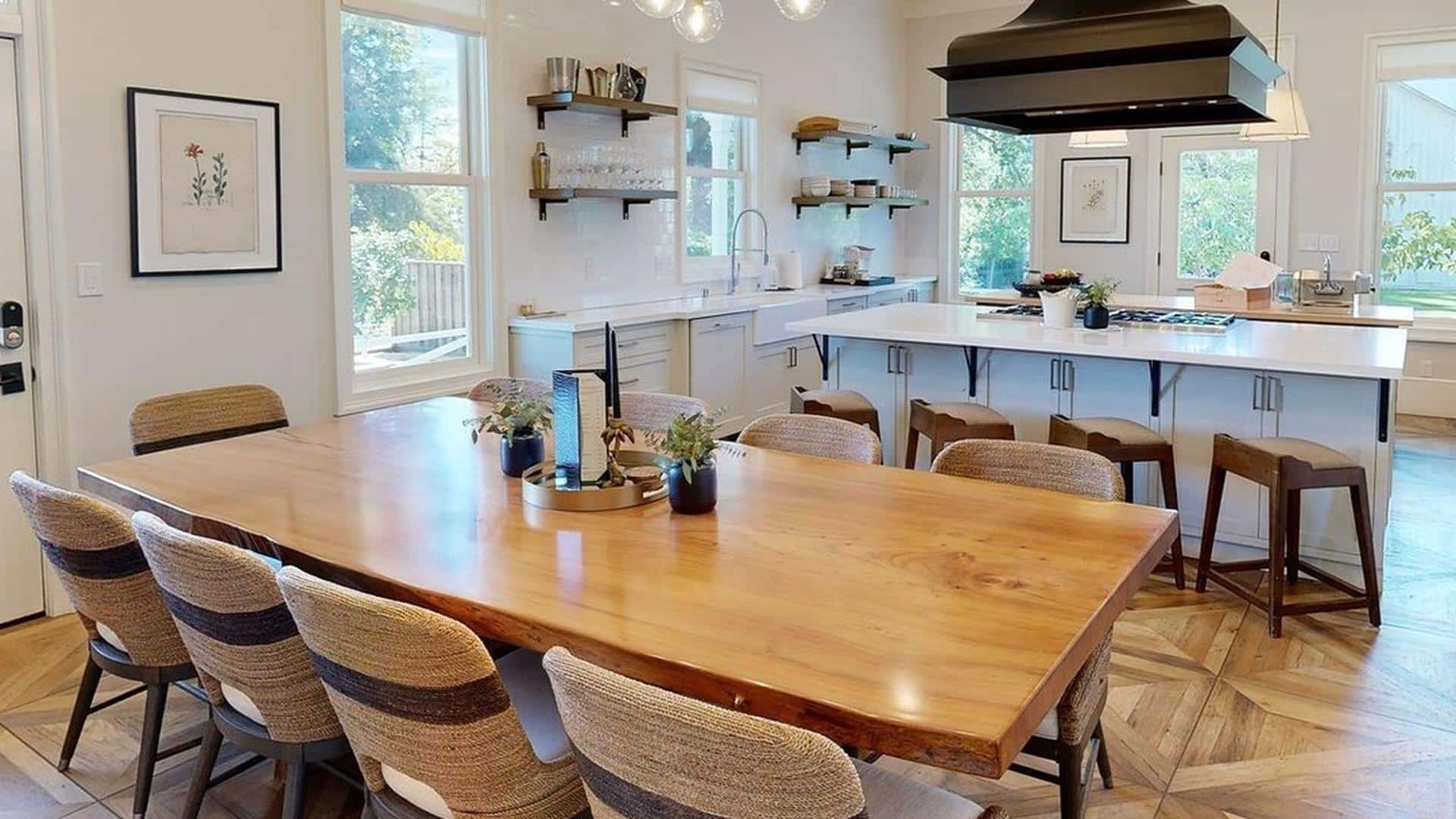 Spacious modern kitchen with wooden dining table.