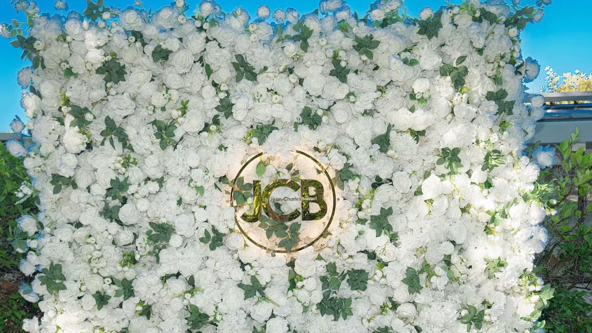 White rose floral wall with JCB monogram