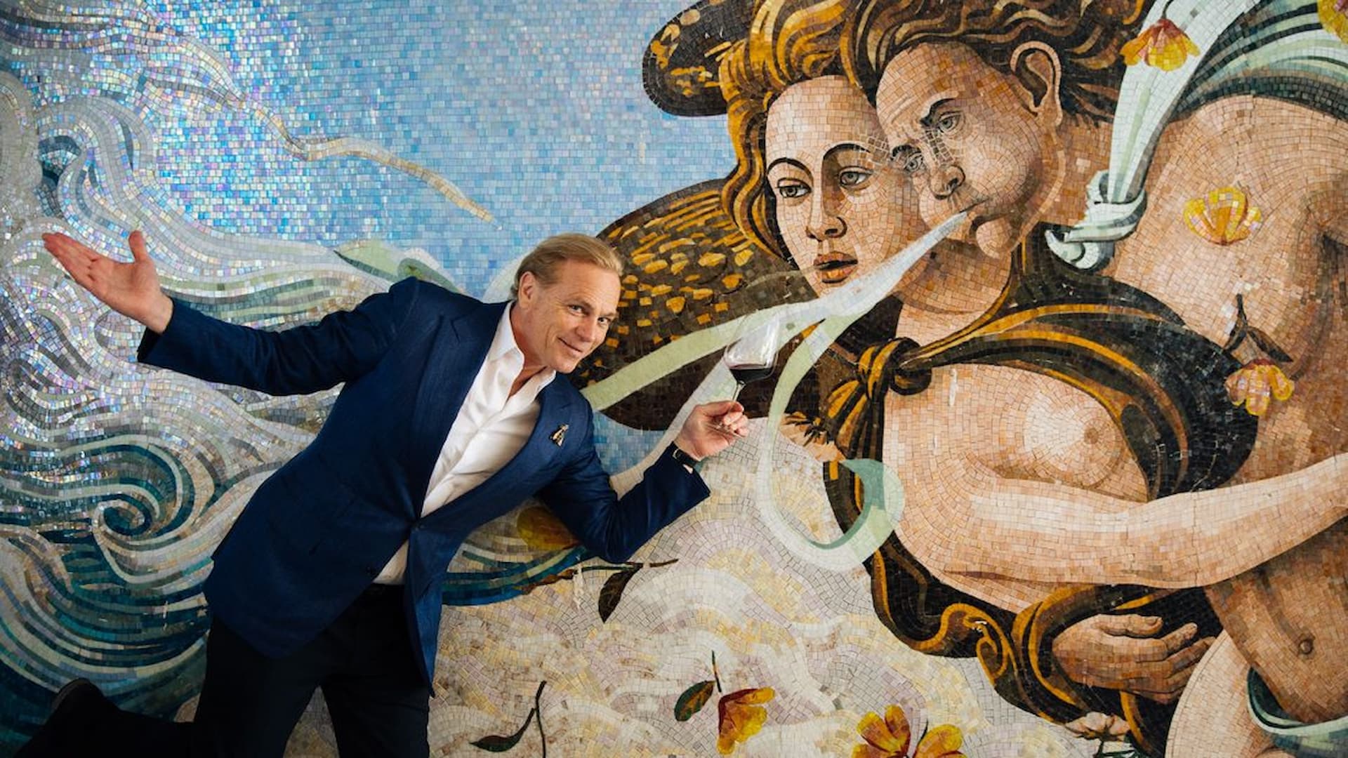 Man posing before classical mosaic mural