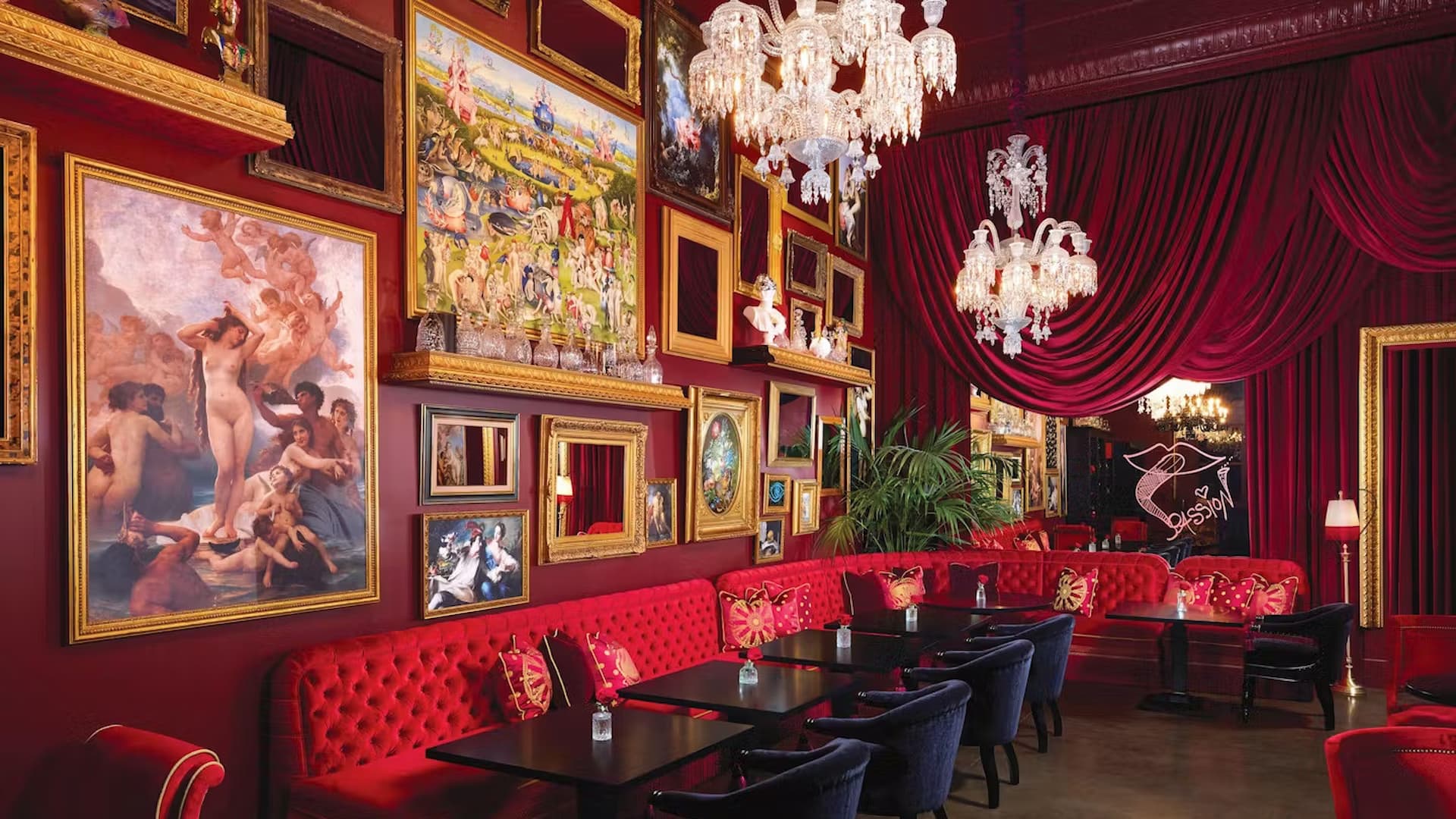 Luxurious red-themed restaurant with ornate decor and art.