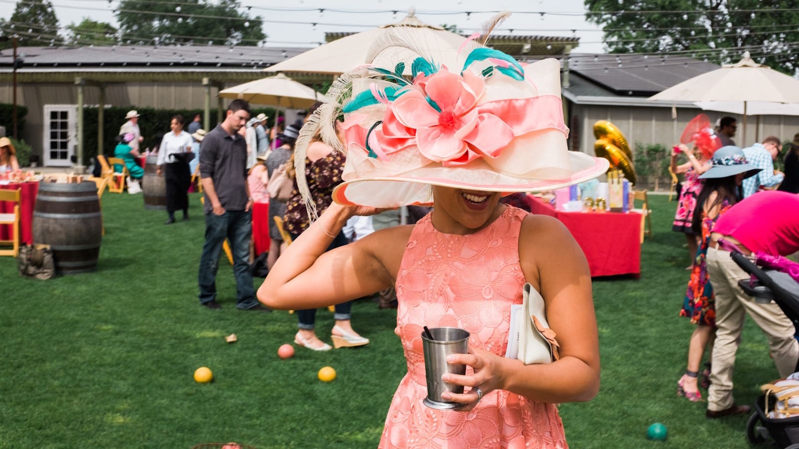 Woman in floral hat at outdoor garden party
