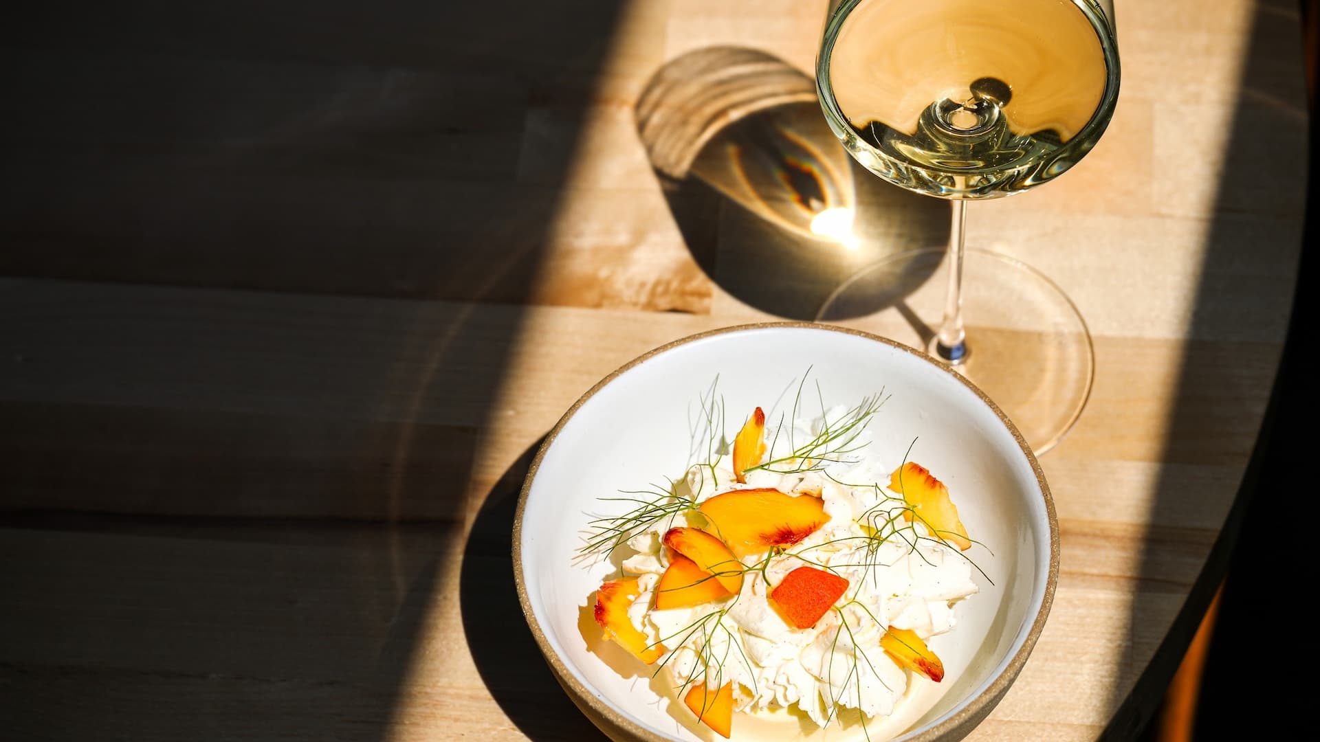 Gourmet dessert with wine glass on wooden table.