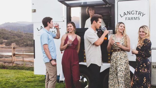 Group enjoying drinks at Langtry Farms wine truck.