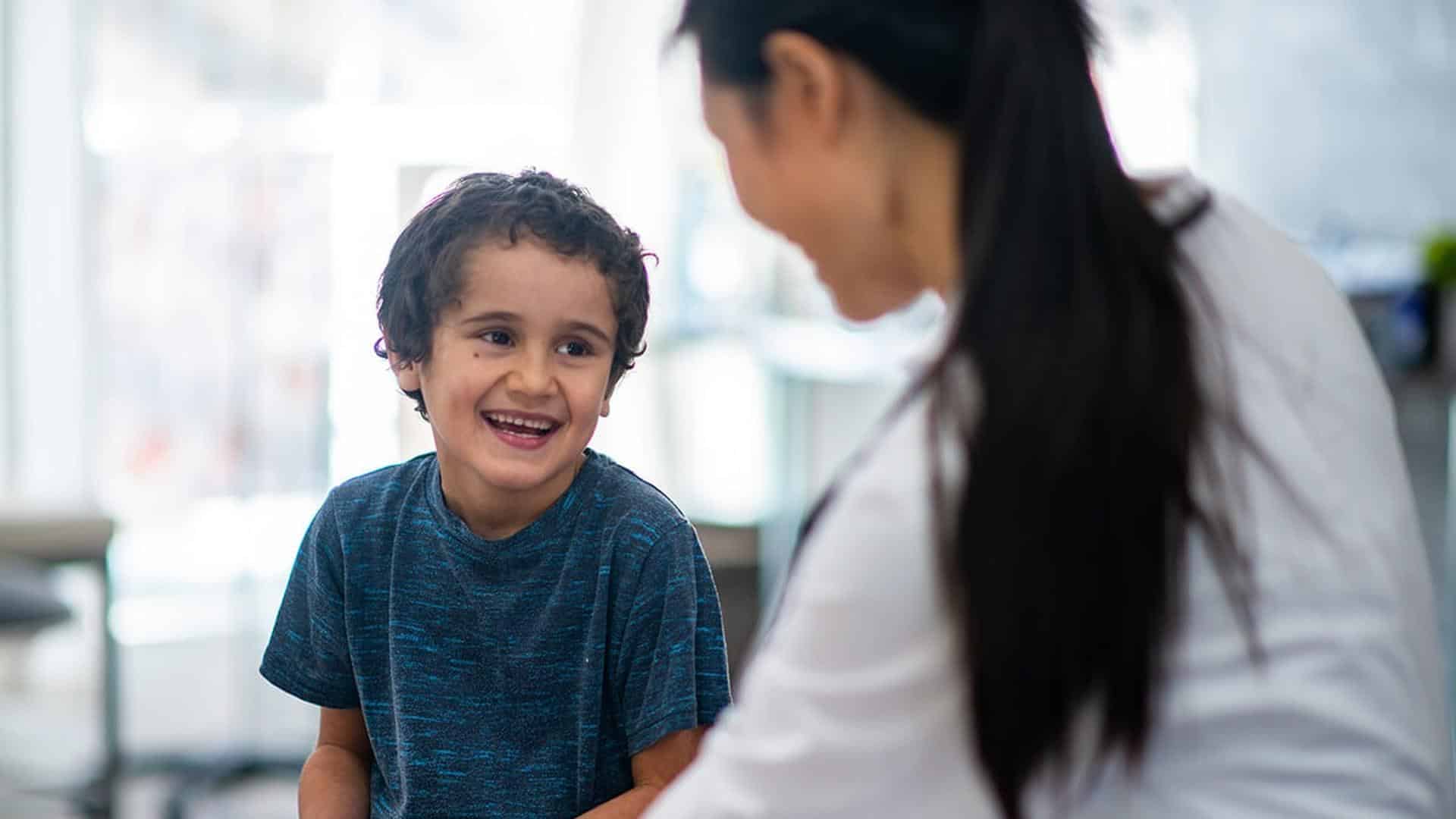 Child smiling at healthcare professional