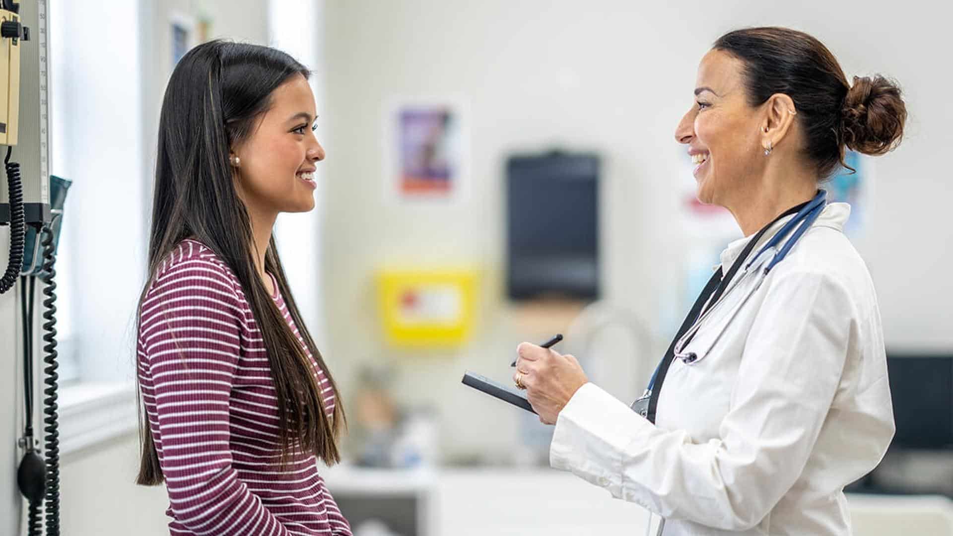 Doctor speaking with patient in office.