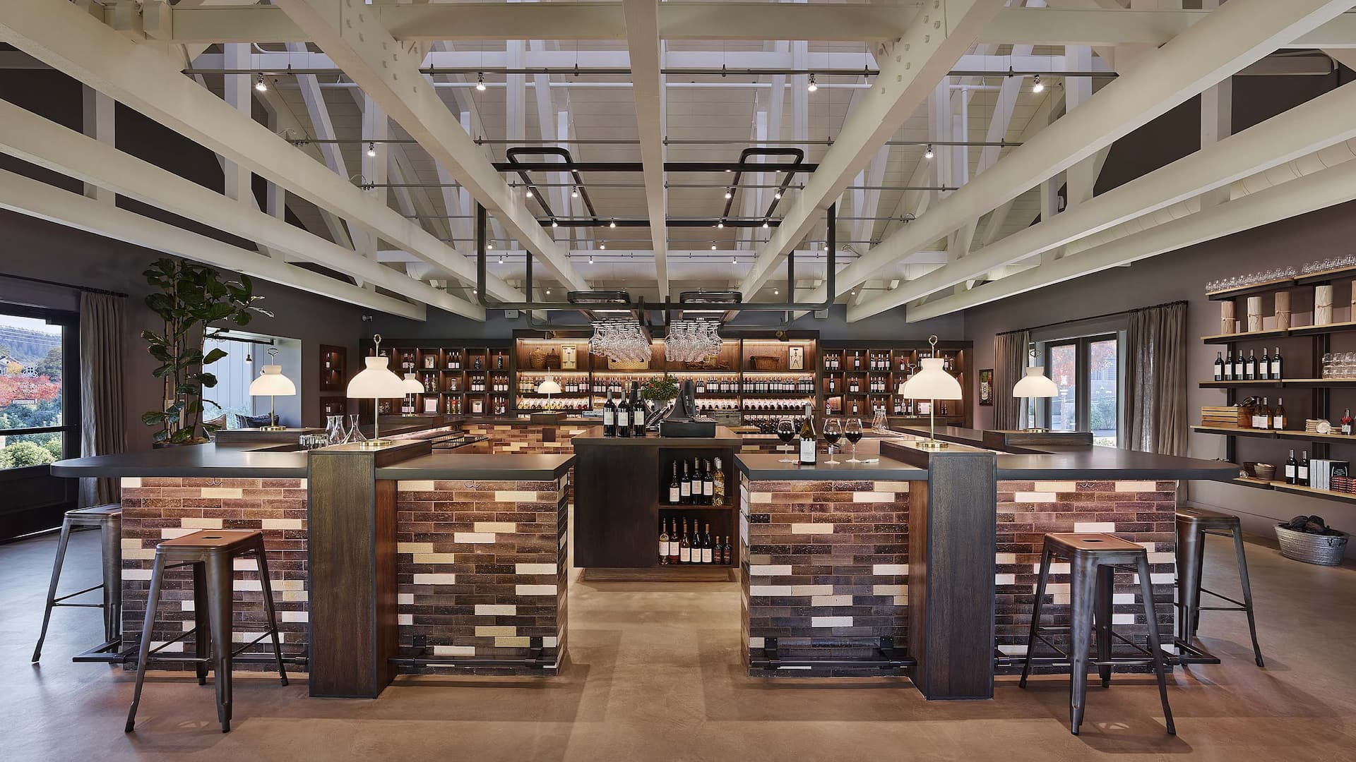 Modern winery tasting room with bar and shelves.