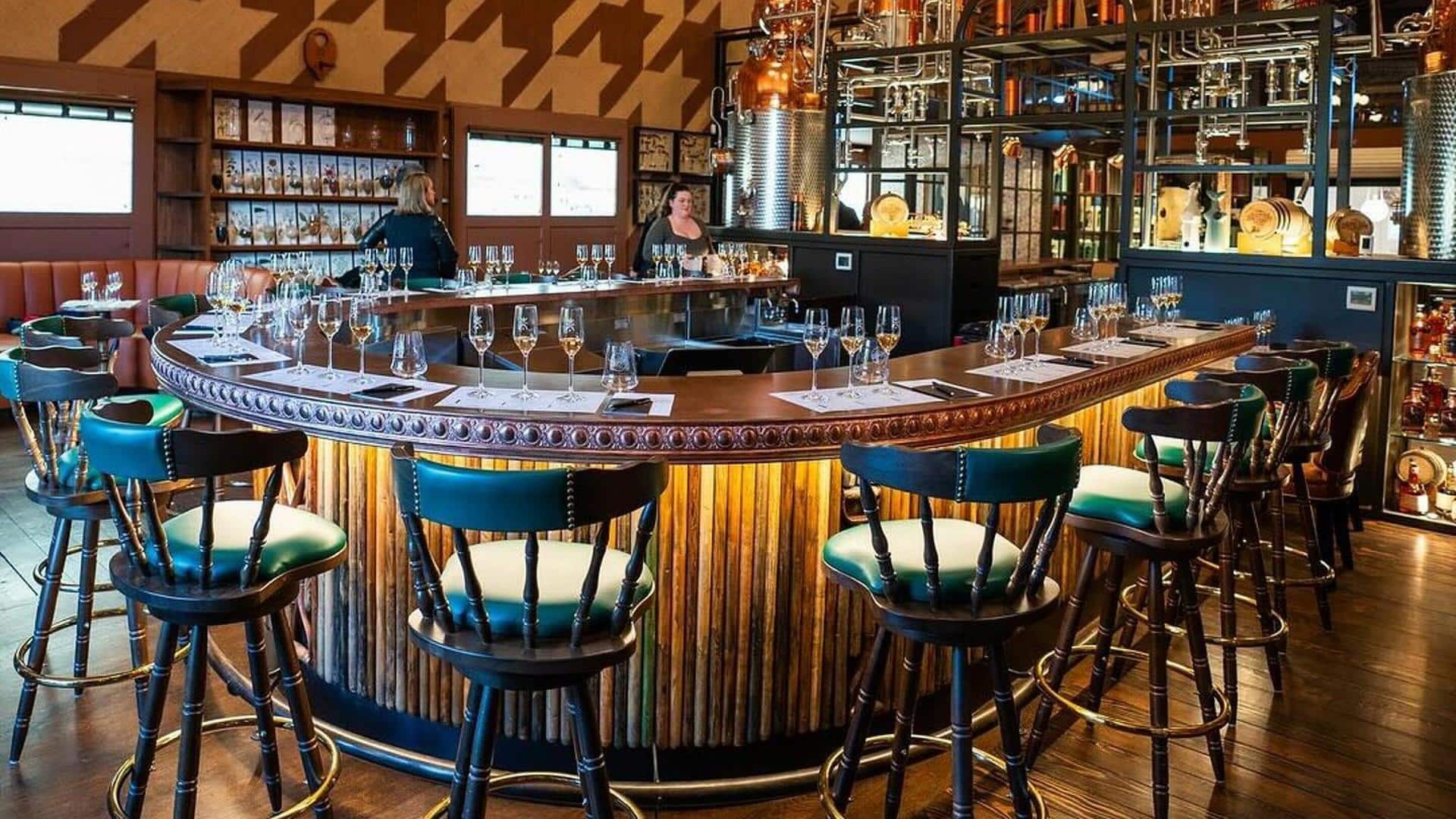 Cozy bar with wooden stools and glasses