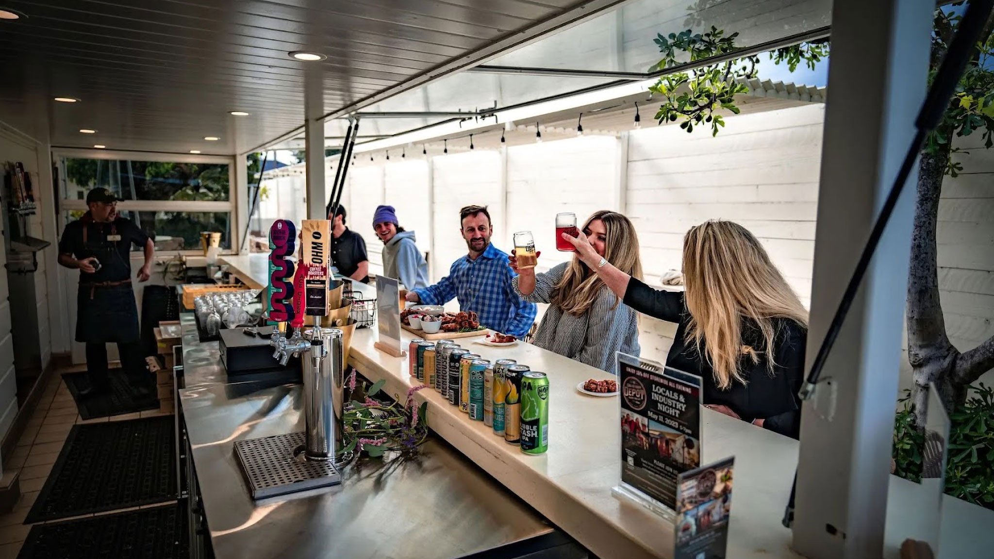 People enjoying drinks at a bar counter.