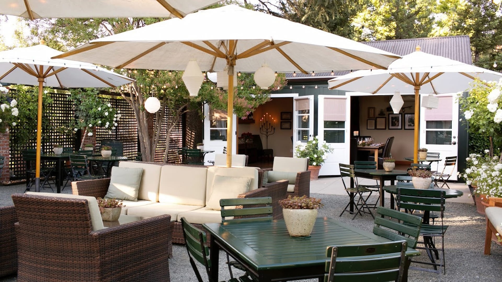 Cozy outdoor patio with tables and umbrellas.