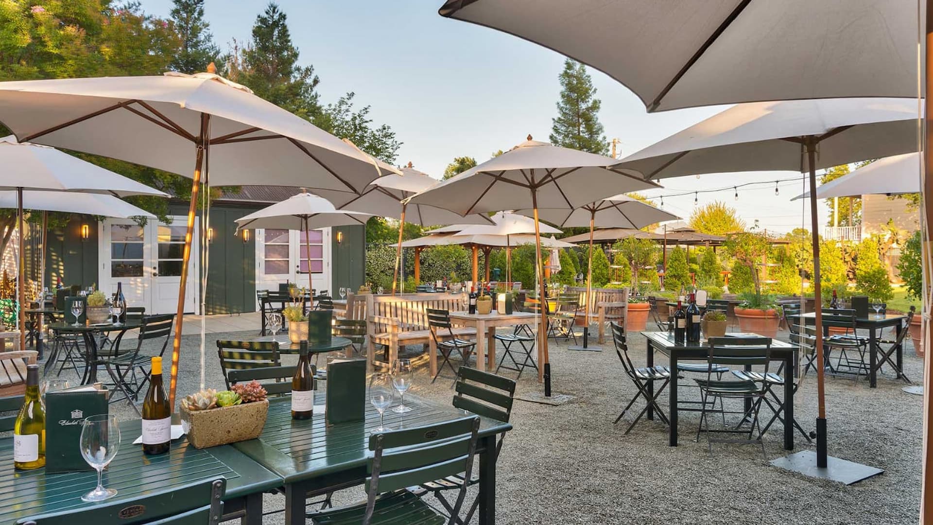 Outdoor restaurant patio with tables and umbrellas.