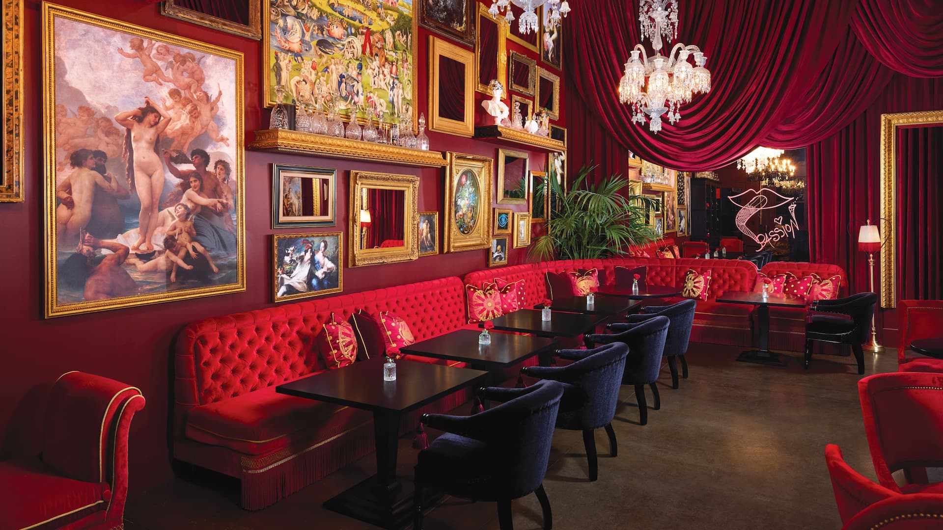Luxurious restaurant with art, red decor, chandeliers.