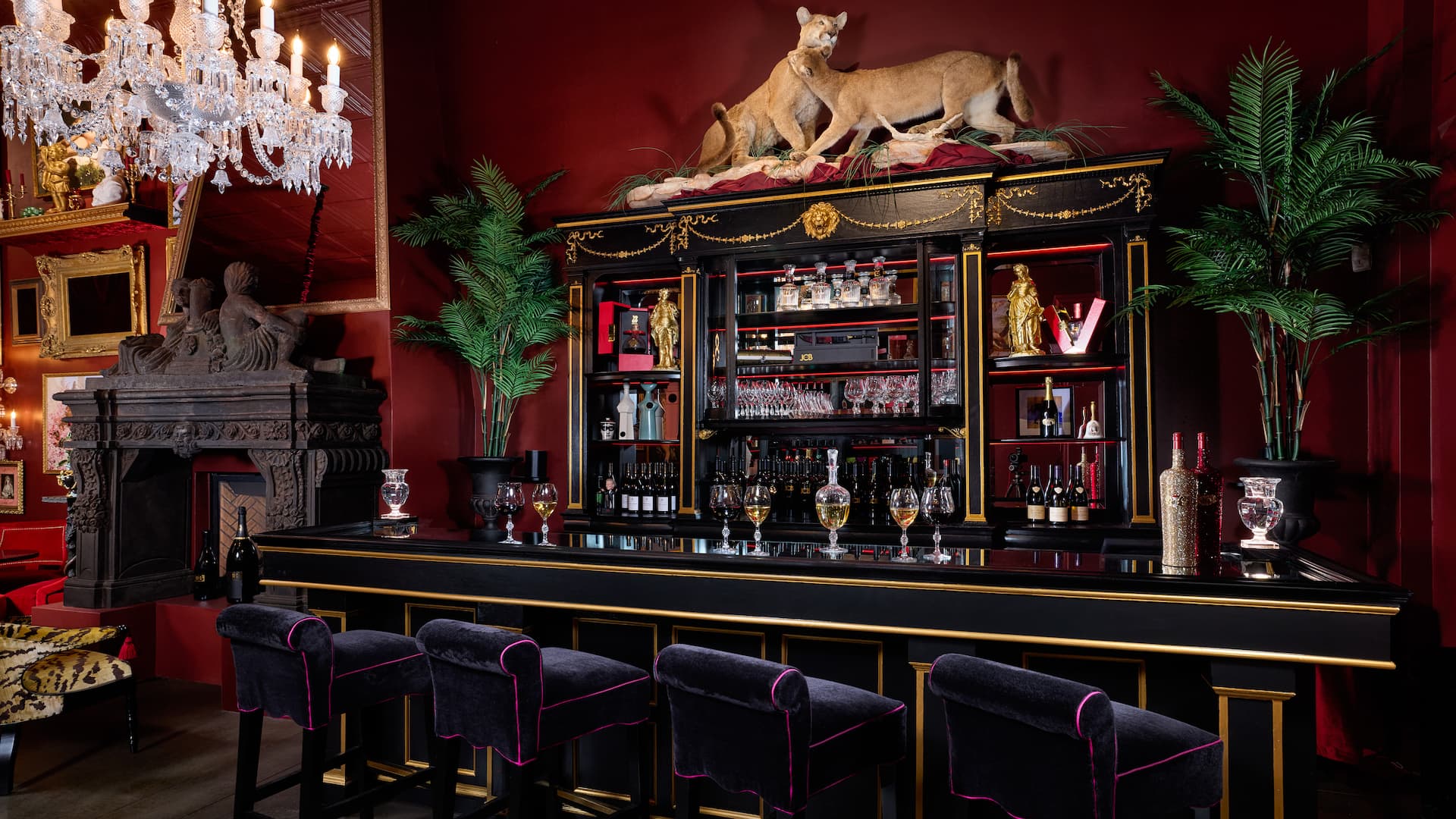 Luxurious bar with velvet stools and chandeliers.