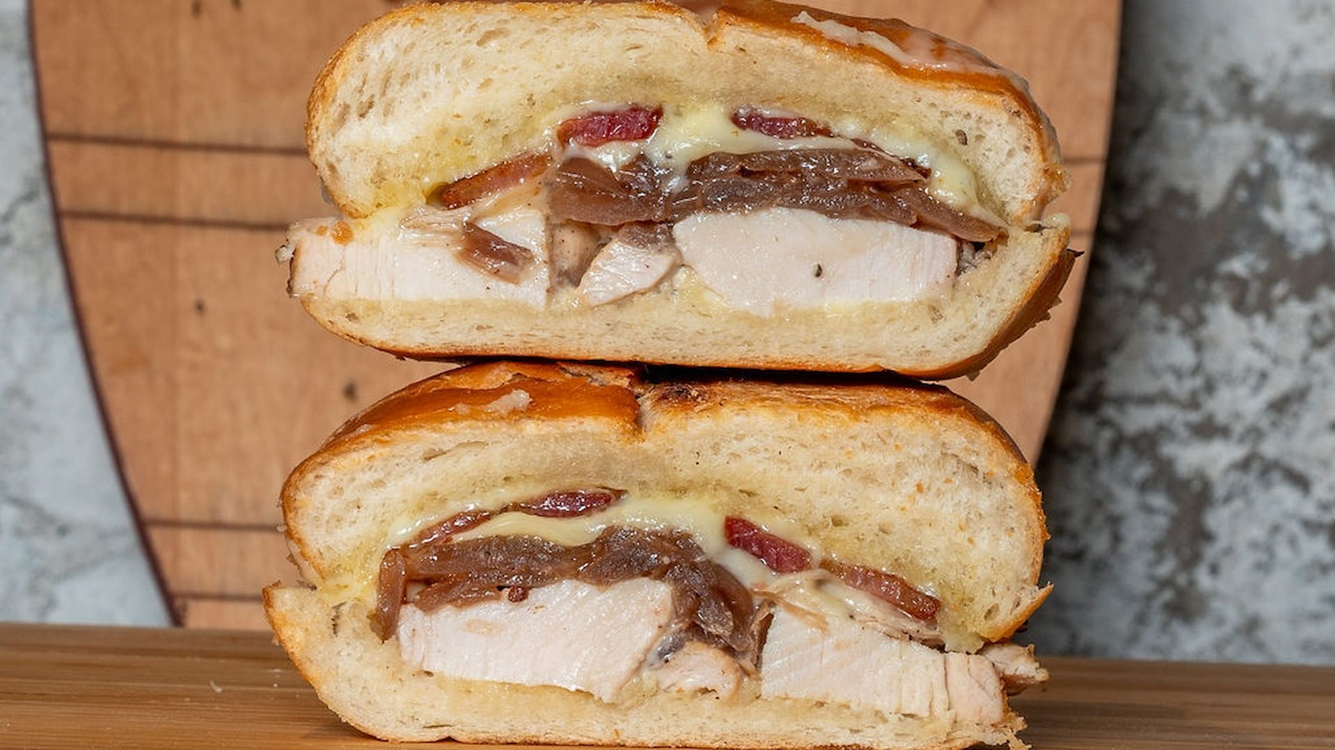 Chicken sandwich with onions and cheese.