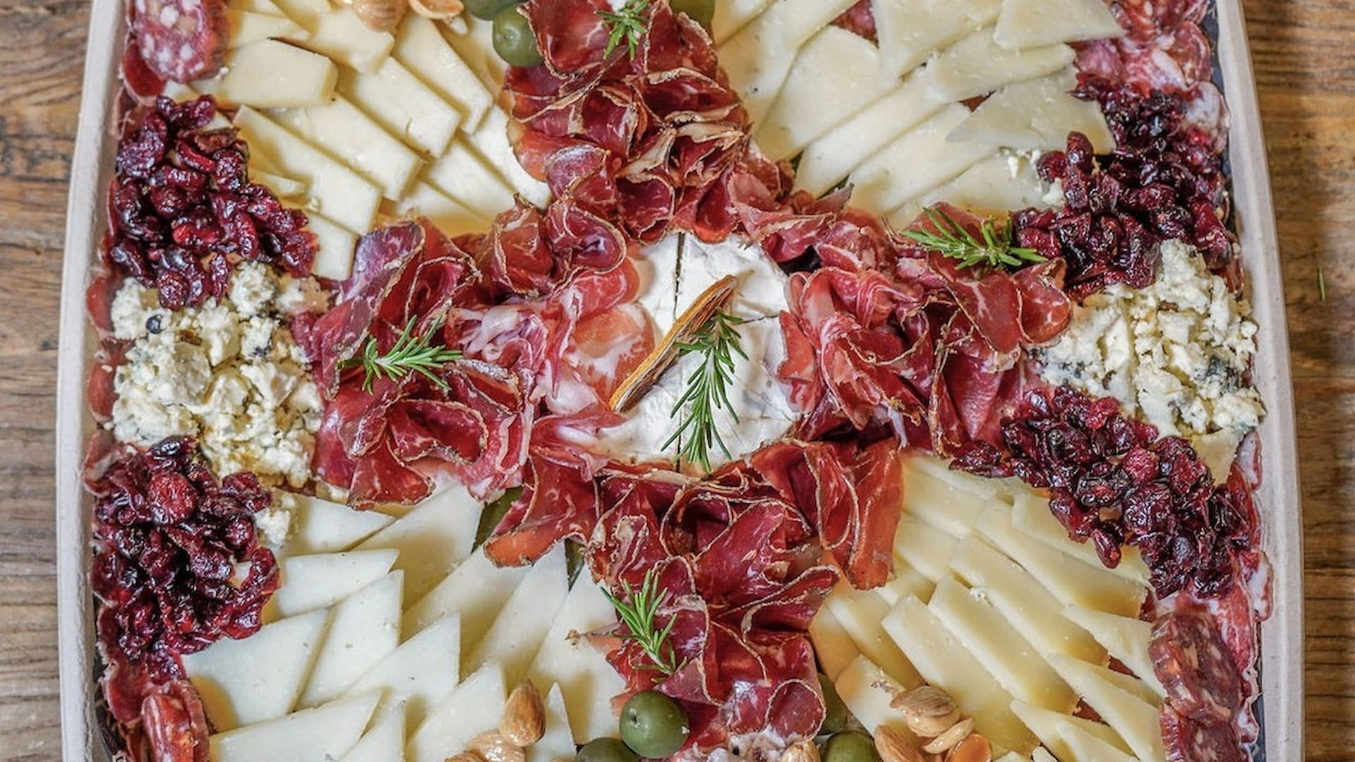 Charcuterie board with cheeses, meats, and garnishes