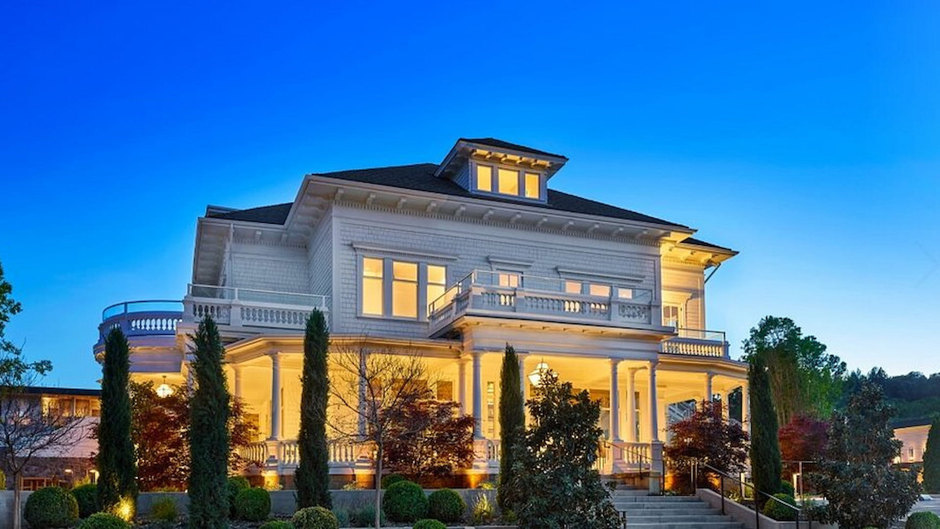 Elegant house with illuminated exterior and garden