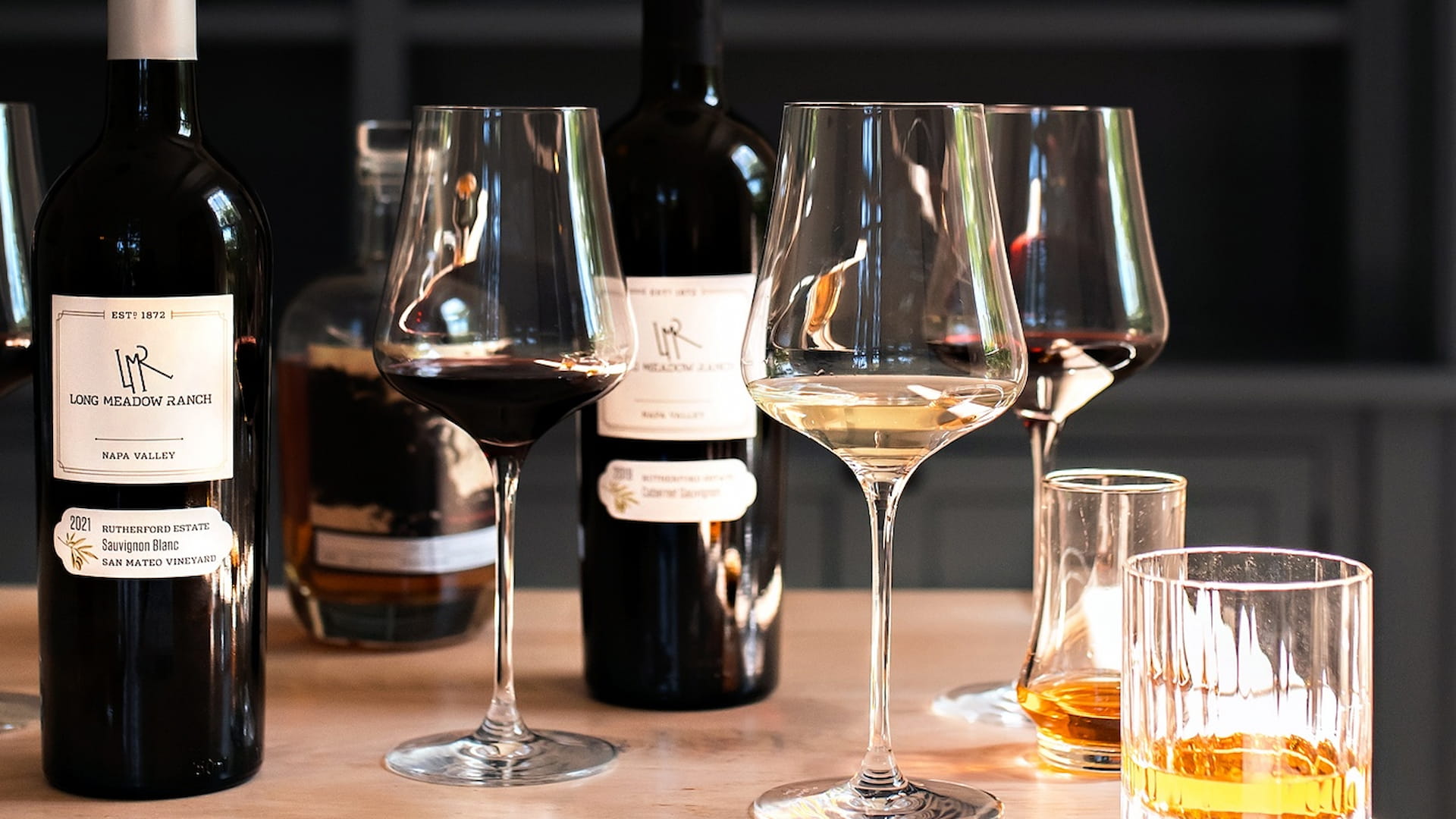 Napa Valley wine and glasses on wooden table.