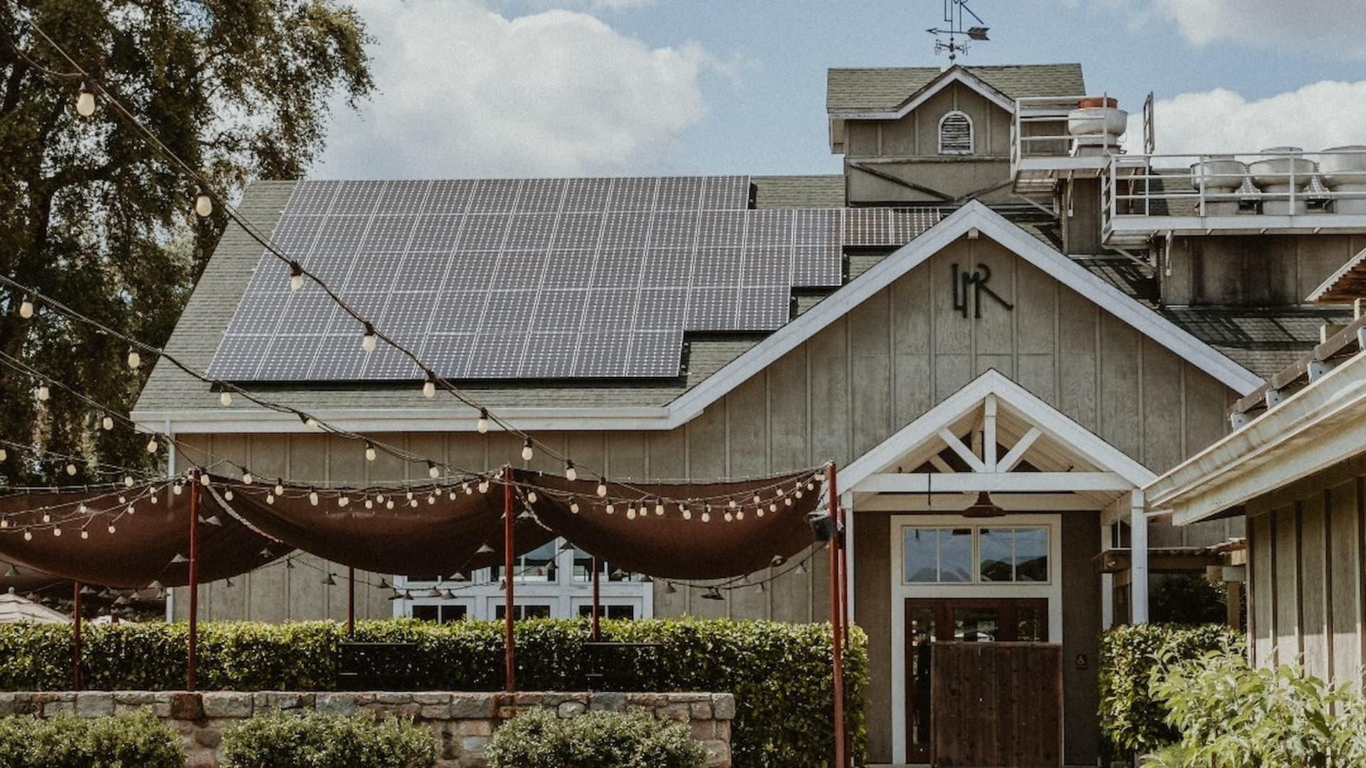 Building with solar panels and string lights