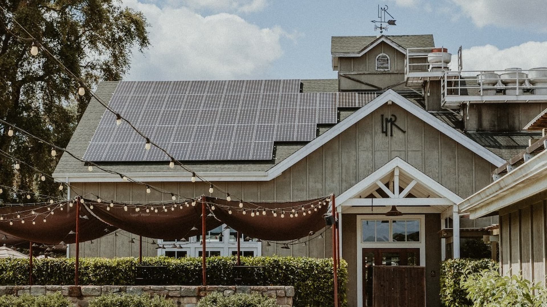 Building with solar panels and string lights