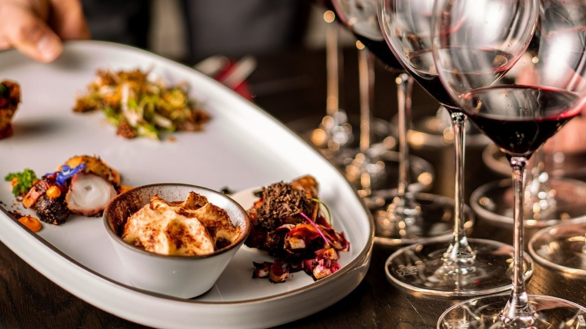 Gourmet dish with wine glasses on table