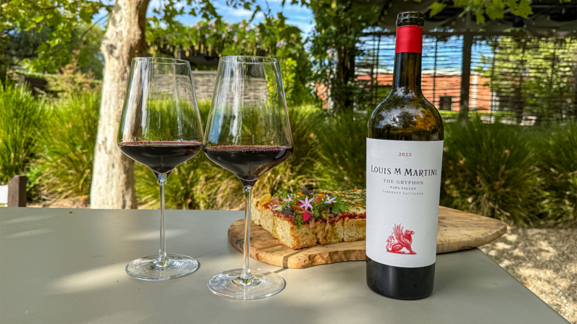 Cabernet Sauvignon with two glasses and focaccia outdoors