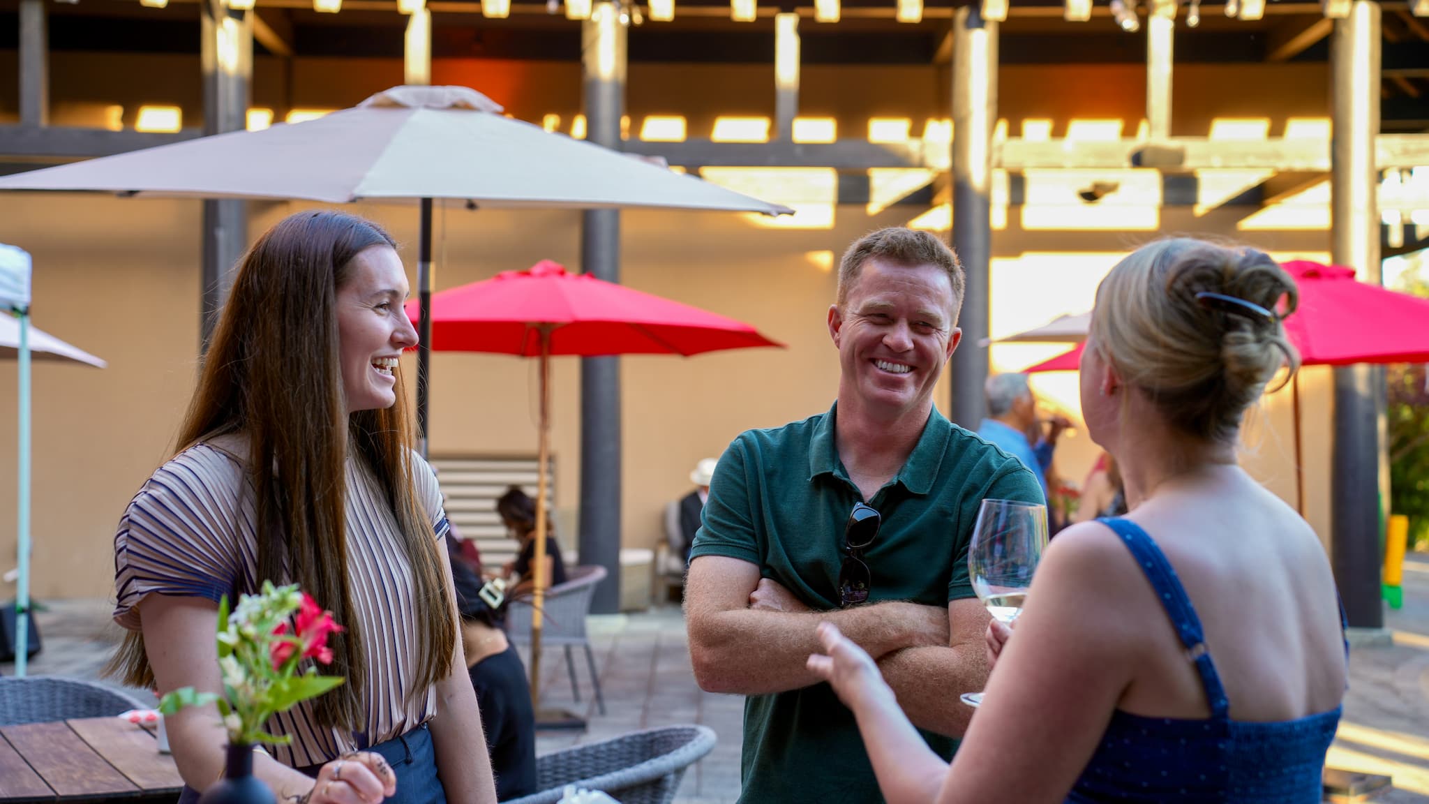 People enjoying conversation at outdoor patio gathering