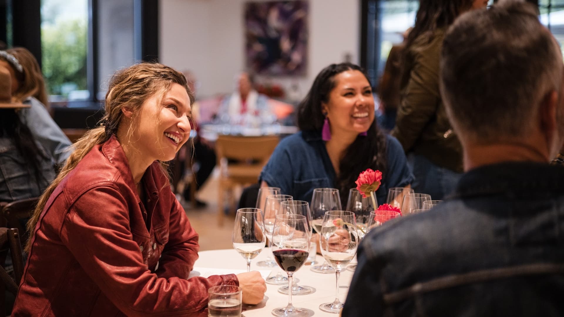 Friends laughing together at a restaurant table