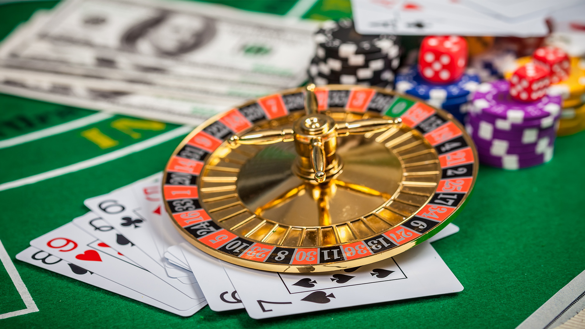 Roulette wheel on cards with chips and dice