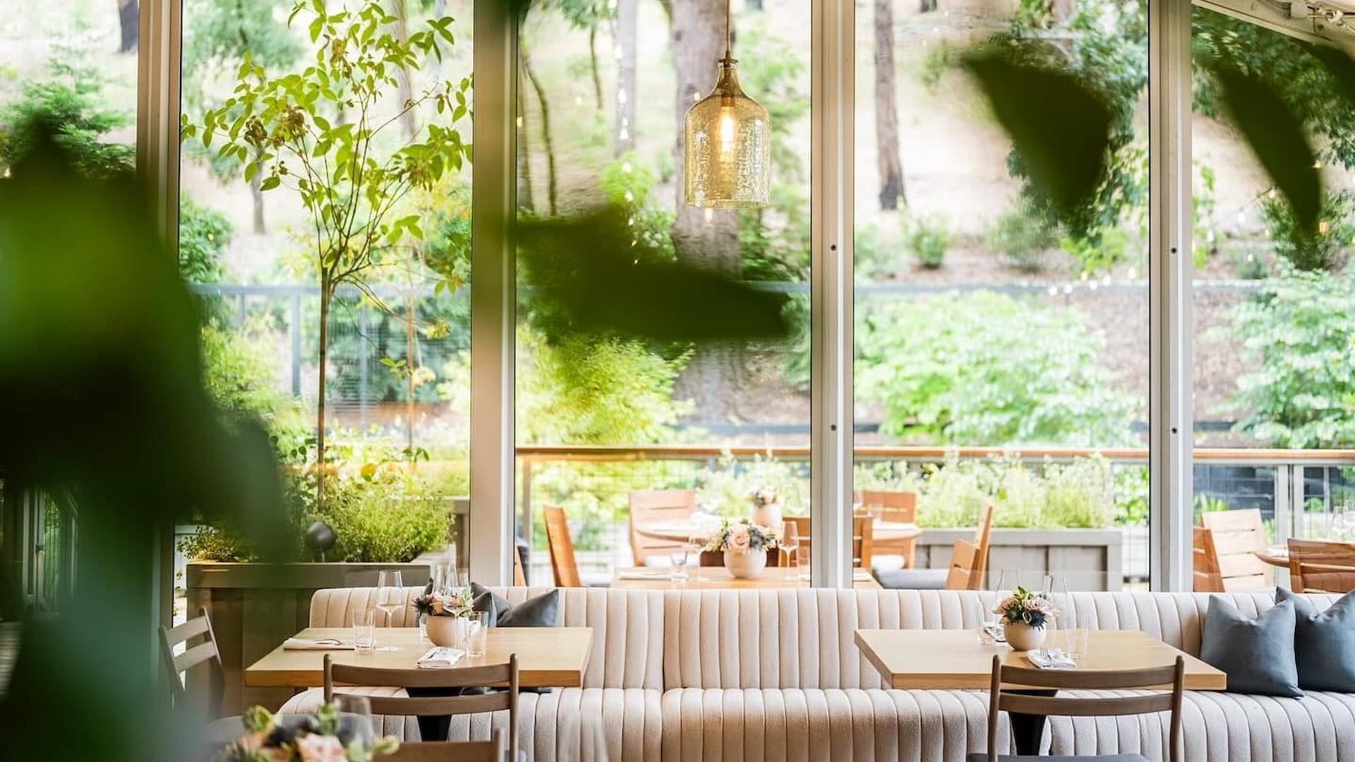 Cozy restaurant with large windows and outdoor view.