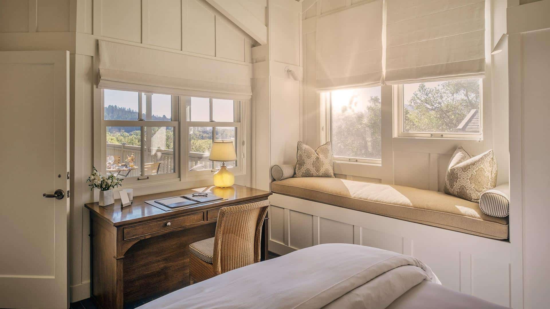 Cozy bedroom with desk and window seating.