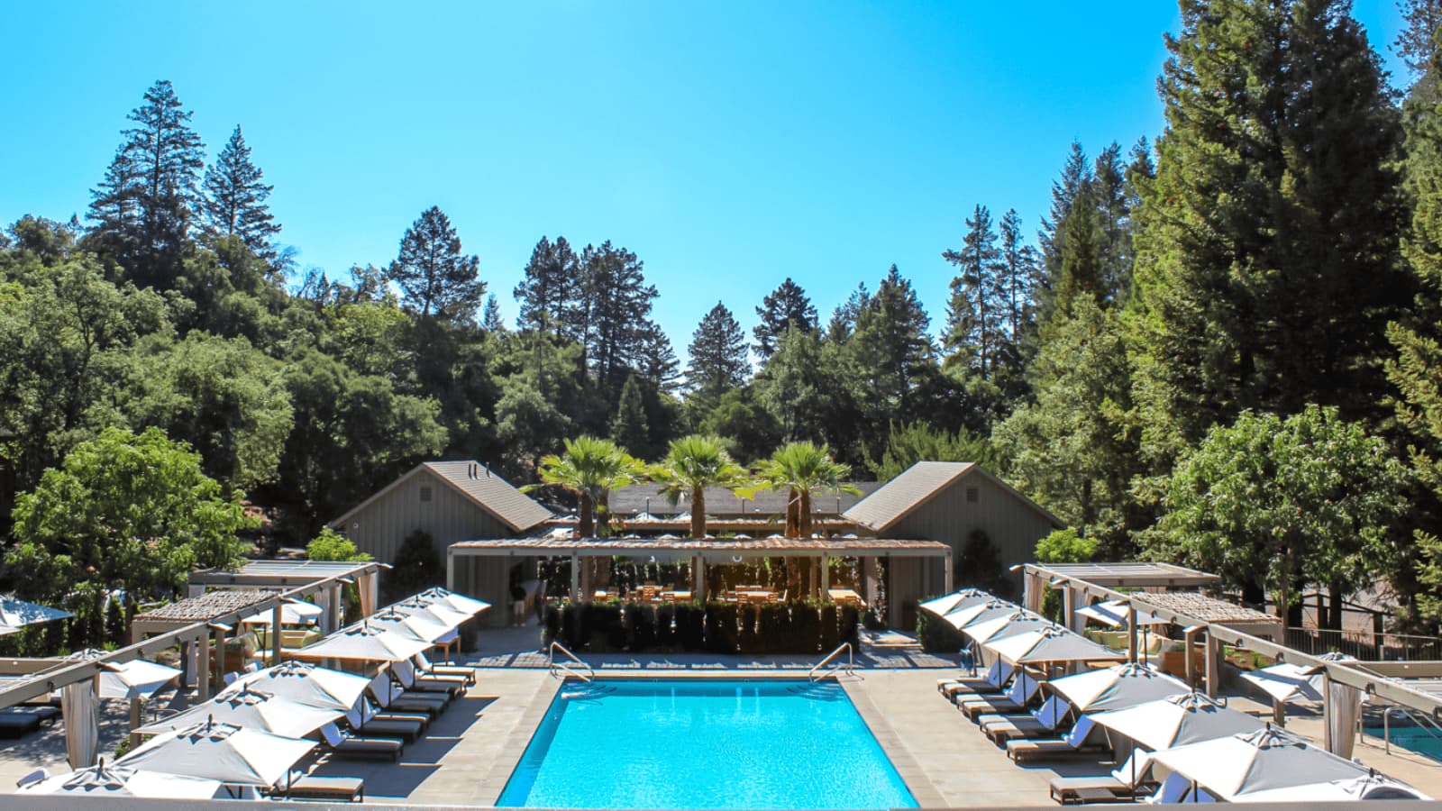 Luxury resort pool with lounge chairs and cabanas