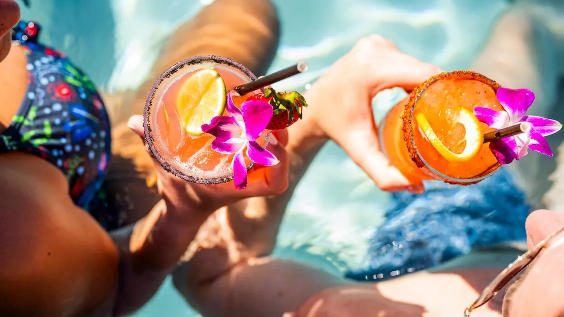 Colorful cocktails with fruit by the pool