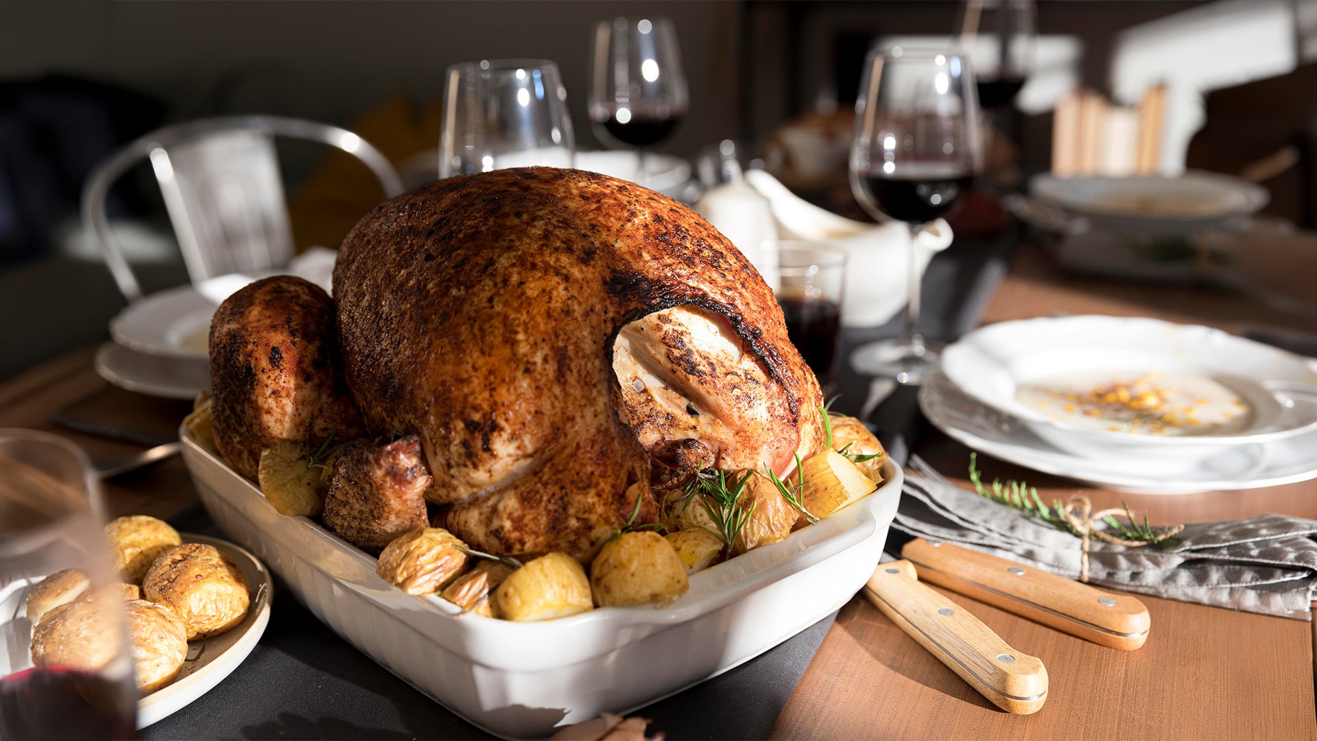 Roasted turkey with potatoes on dining table