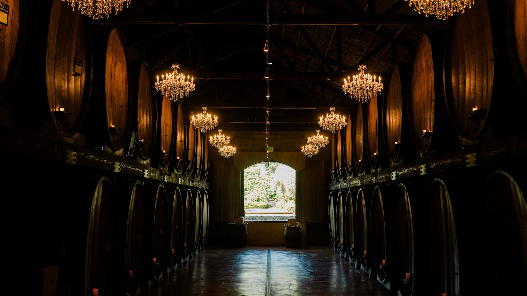 Wine cellar with large barrels and chandeliers