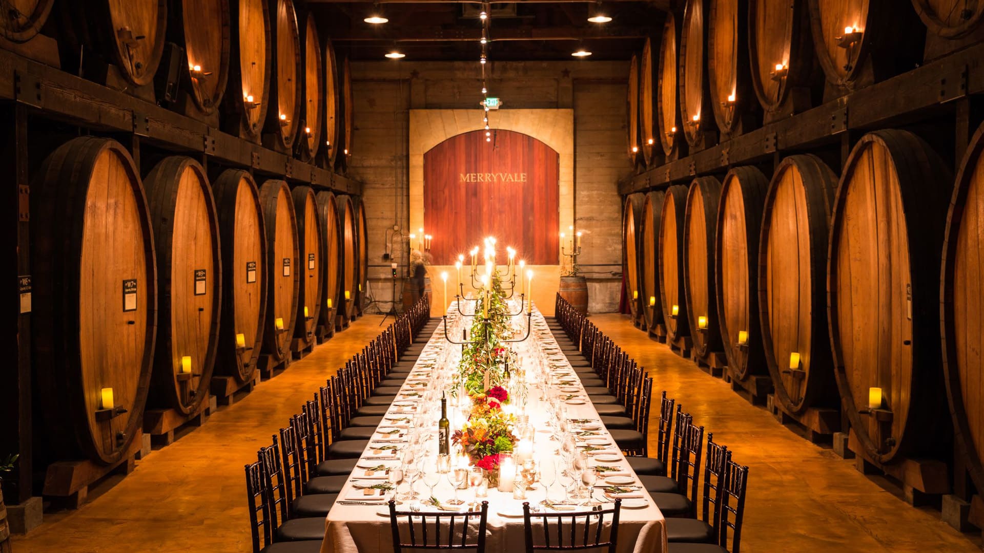 Elegant dinner setup in a wine cellar.