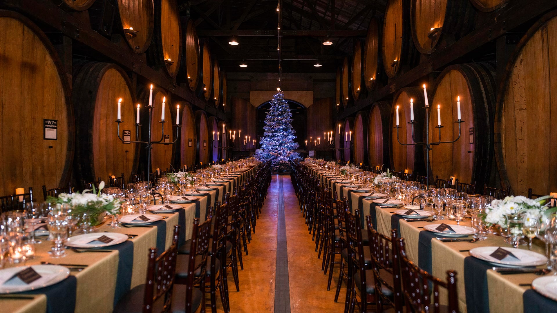 Candlelit holiday banquet in a barrel-lined winery cellar
